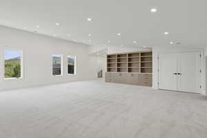 Bonus room featuring recessed lighting, light carpet, and vaulted ceiling