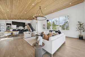 Living area featuring light wood-style floors, wood ceiling, a chandelier, and recessed lighting