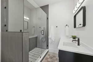 Bathroom featuring double vanity and a shower stall