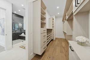 Spacious closet with light wood-style flooring