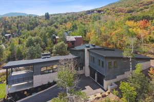 View from above of property featuring a forest and mountains