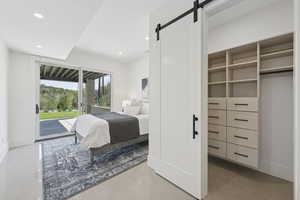 Bedroom featuring access to outside, a barn door, recessed lighting, and concrete flooring