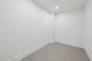 Unfurnished room with concrete floors and recessed lighting