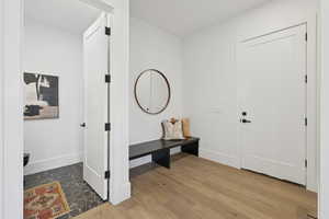 Foyer entrance featuring dark wood finished floors and baseboards