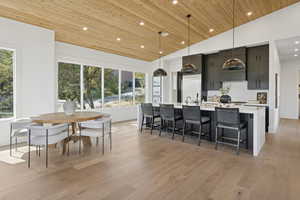 Dining space featuring wooden ceiling, recessed lighting, light wood-style flooring, and high vaulted ceiling