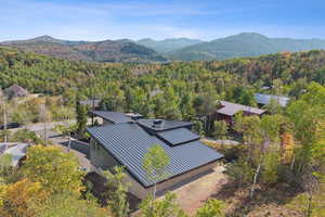 Aerial view of property and surrounding area with a mountainous background