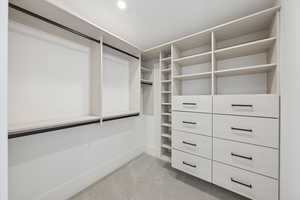 Walk in closet featuring light carpet
