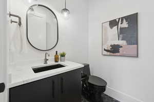 Half bath with vanity and toilet