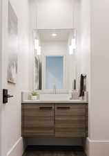 Bathroom with vanity and dark wood-type flooring