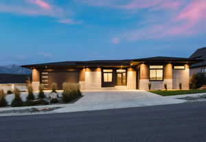 Prairie-style home featuring driveway and a garage