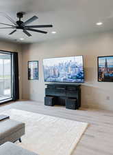 Living room with recessed lighting, light wood finished floors, and a ceiling fan