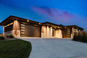 Contemporary home featuring a garage and concrete driveway
