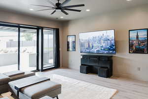 Living room with recessed lighting, light wood-style floors, and a ceiling fan