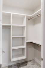 Walk in closet featuring light carpet