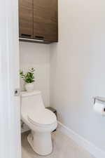 Bathroom with baseboards and light tile patterned floors