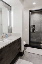 Full bathroom featuring vanity, a stall shower, and recessed lighting