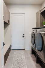 Laundry area with washer and clothes dryer and baseboards