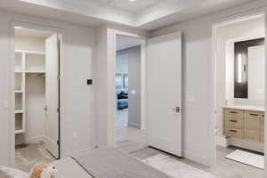 Bedroom featuring a spacious closet and light wood finished floors