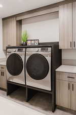 Laundry area with washing machine and clothes dryer and cabinet space