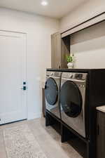 Laundry room with recessed lighting and washing machine and clothes dryer