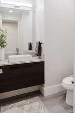 Half bath with vanity and light wood-style flooring