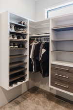 Spacious closet with light carpet