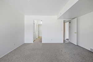 Carpeted empty room with baseboards