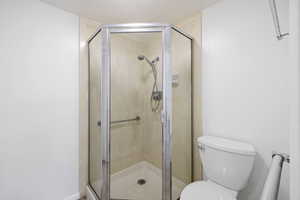 Bathroom with a stall shower and toilet
