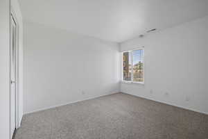 Unfurnished bedroom featuring carpet and a closet