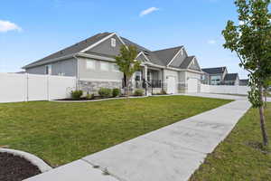 Craftsman-style house with stone siding, stucco siding, driveway, and an attached garage