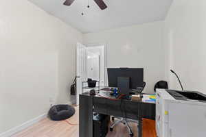 Home office featuring light wood-type flooring and ceiling fan
