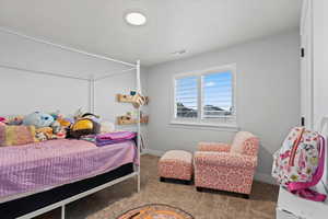 Bedroom featuring carpet floors and baseboards