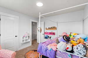 Bedroom featuring carpet and a closet