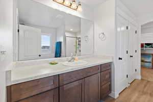 Full bathroom featuring vanity, light wood-style floors, and a shower with shower curtain