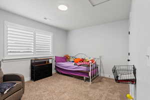 Bedroom with light carpet and baseboards