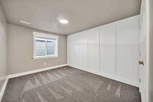 Spare room with carpet floors and baseboards