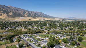 Aerial view of property's location featuring a mountain backdrop and nearby suburban area