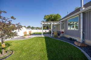 Fenced backyard with a pergola and a patio