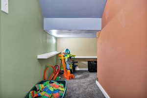 Playroom featuring carpet flooring and baseboards
