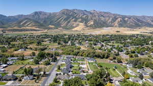 Aerial overview of property's location featuring nearby suburban area and mountains