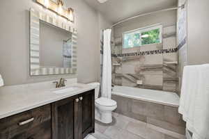 Full bathroom featuring tiled shower / bath combo and vanity