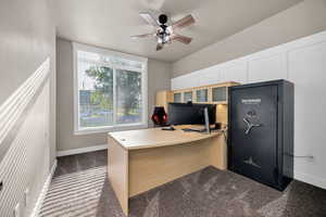 Office with dark carpet and a ceiling fan