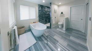 Primary Full bathroom with a soaking tub, a marble finish shower, and recessed lighting