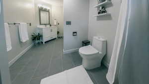 Full bath featuring light tile patterned floors, vanity, and a shower with curtain
