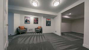 Sitting room featuring dark carpet and recessed lighting