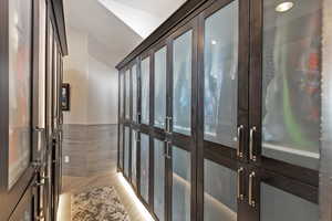 Interior space featuring light wood-type flooring, tile walls, and french doors