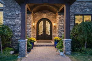 Entrance to property with stone siding and covered porch
