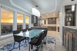 Dining room featuring light wood-style floors, plenty of natural light, crown molding, recessed lighting, and a chandelier