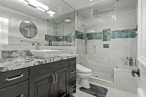 Bathroom featuring vanity and a shower stall