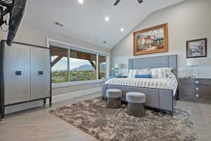 Bedroom featuring high vaulted ceiling, a mountain view, light wood-type flooring, recessed lighting, and ceiling fan